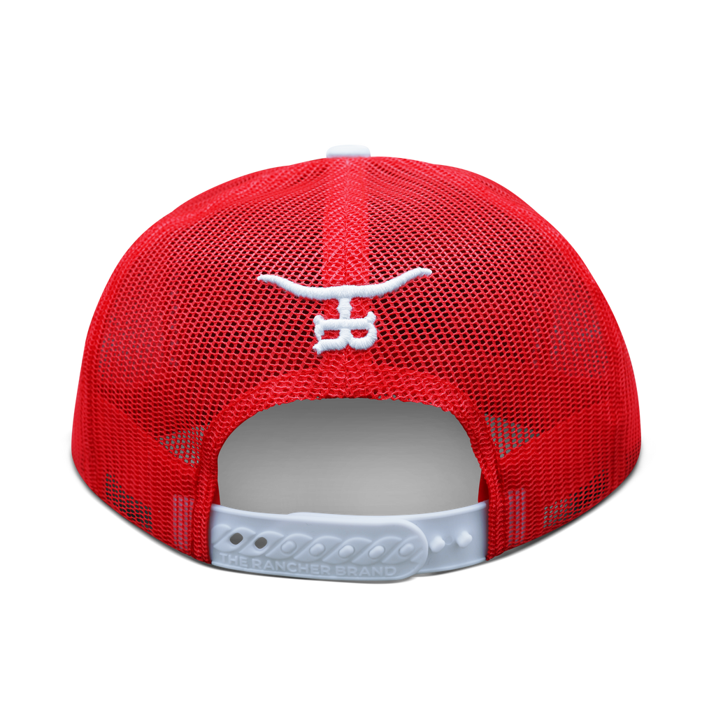 Free Hand bronc rider trucker hat held in hand, red and white colorway with white flat brim by The Rancher Hat Co.