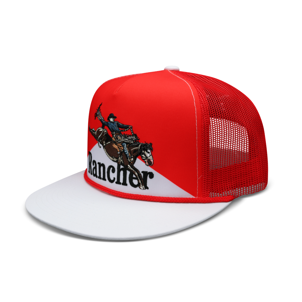 Free Hand red and white flat bill trucker hat, angled view showing embroidered bronc rider and red mesh back